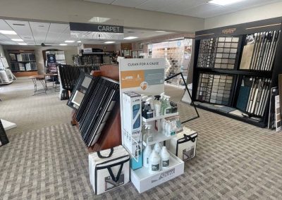 A display of cleaning products at Eastman’s Carpets Inc, surrounded by carpet samples and flooring displays.